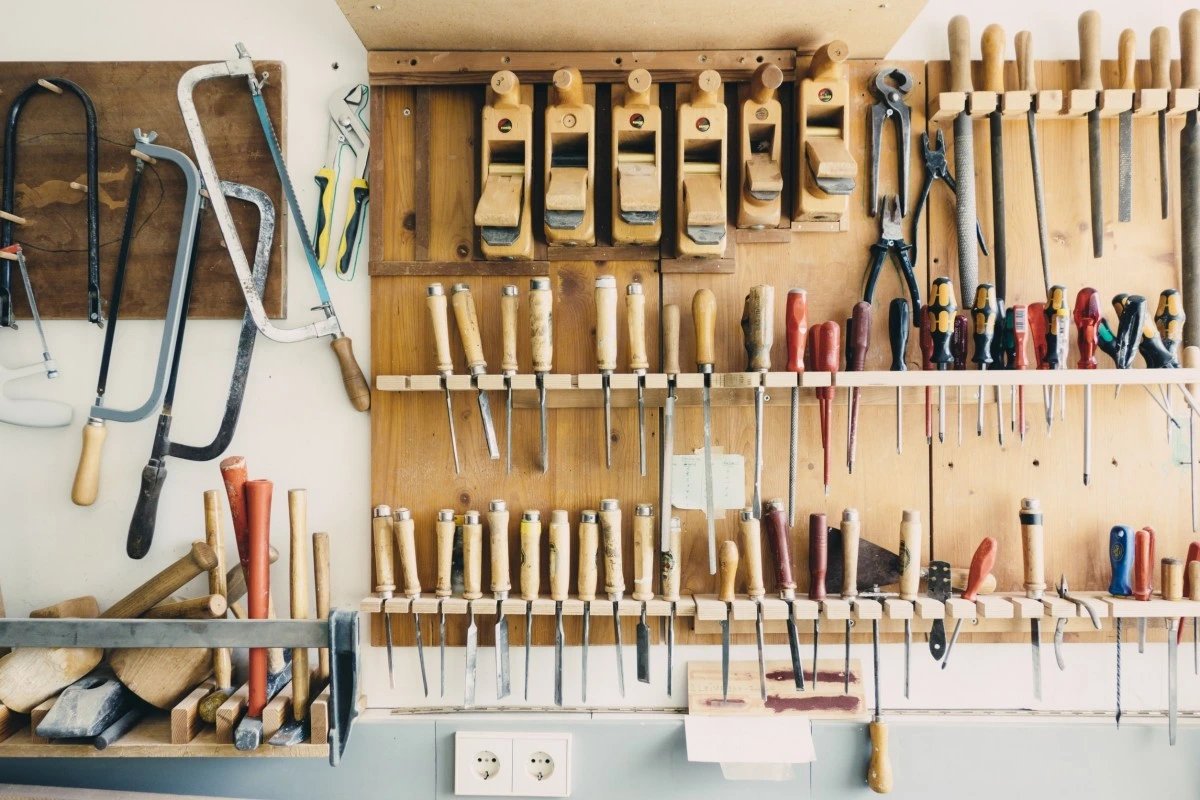 Well-organized workshop with pegboard tool storage, labeled containers, and efficient layout systems